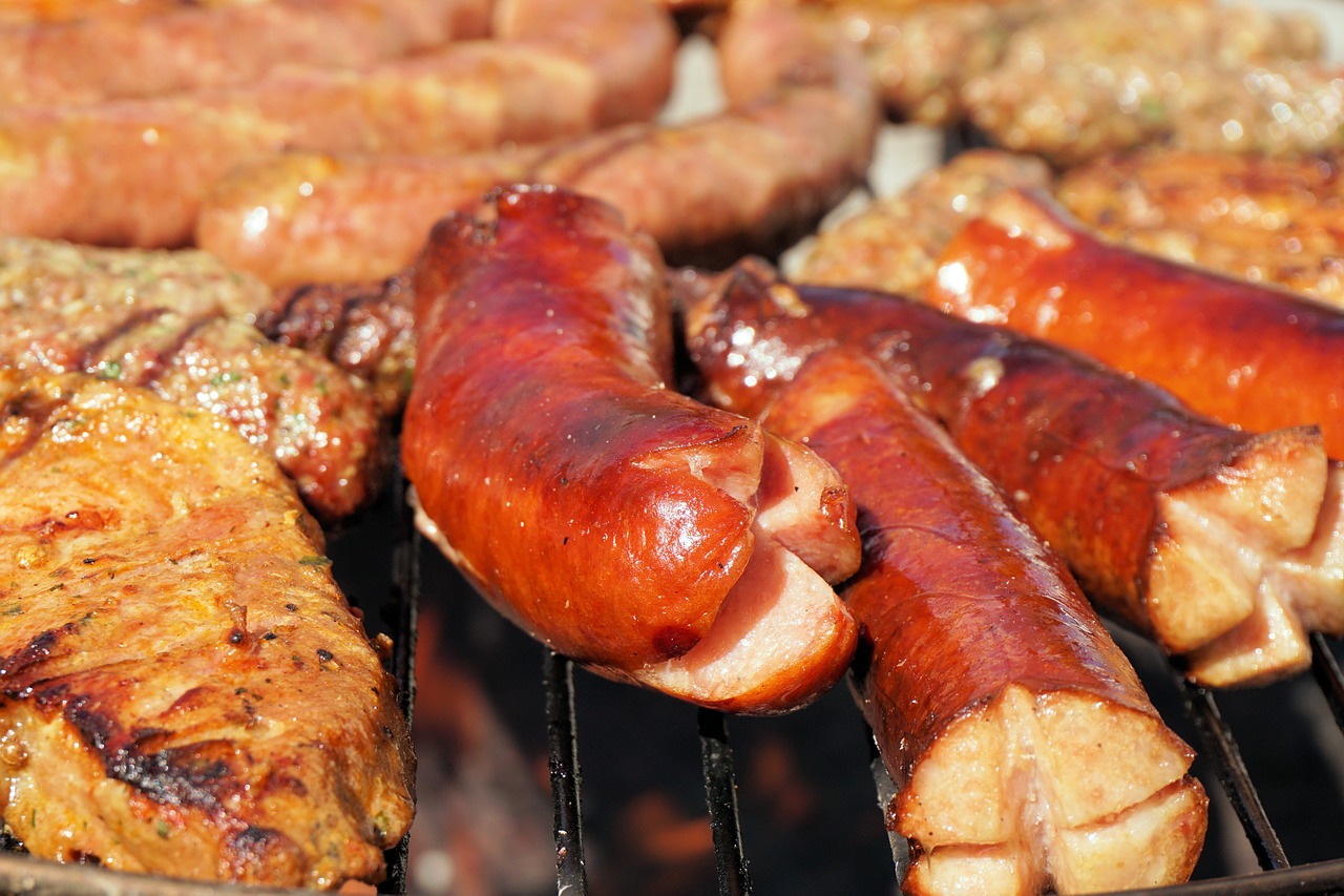 lots of sausages on the grill