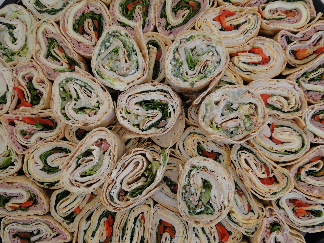 A large platter of turkey wraps placed vertically
