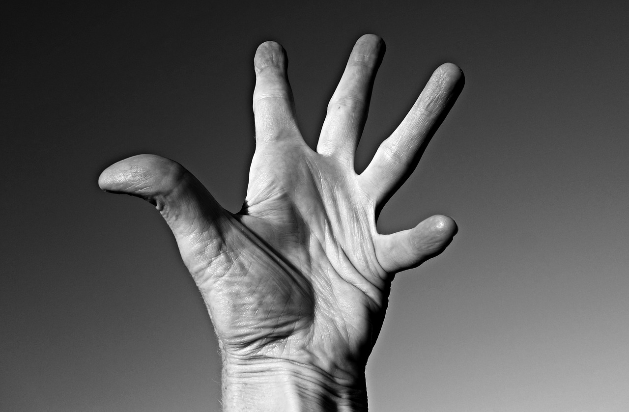 a hand on a black background focusing on the joints in the fingers