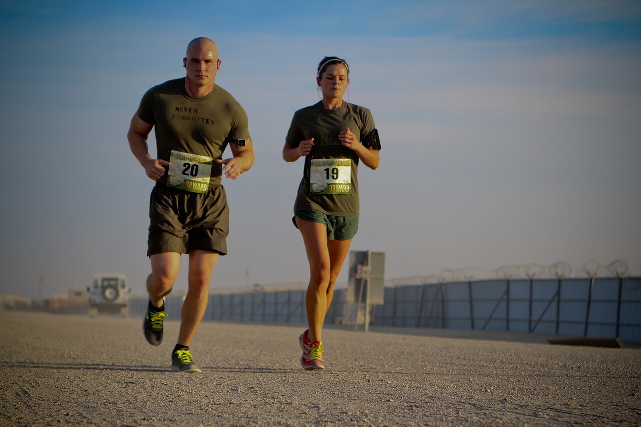 A man and a woman in a military clothes running on a beach