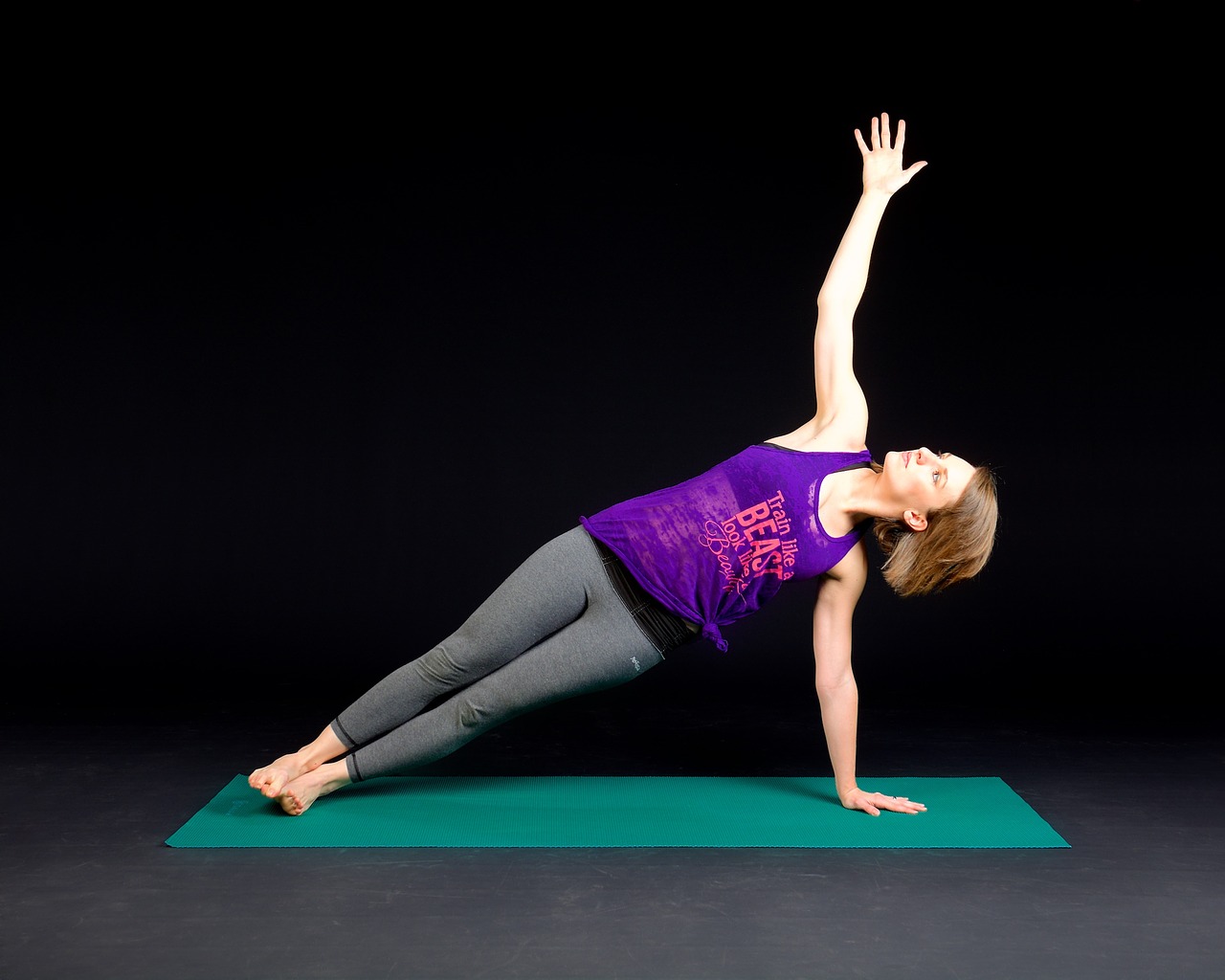 woman doing a plank on a yoga mat